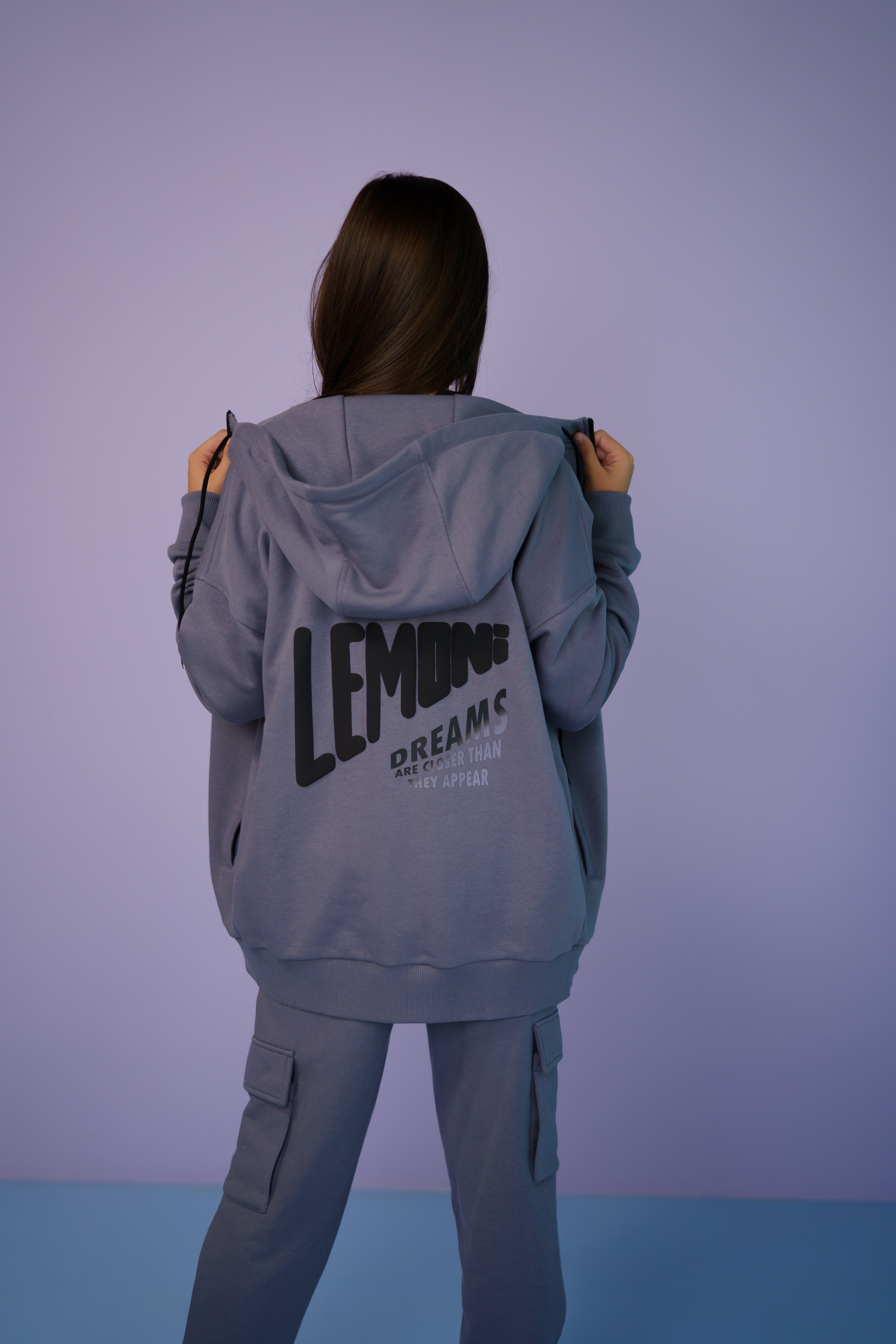 girl wearing a gray tracksuit - backside