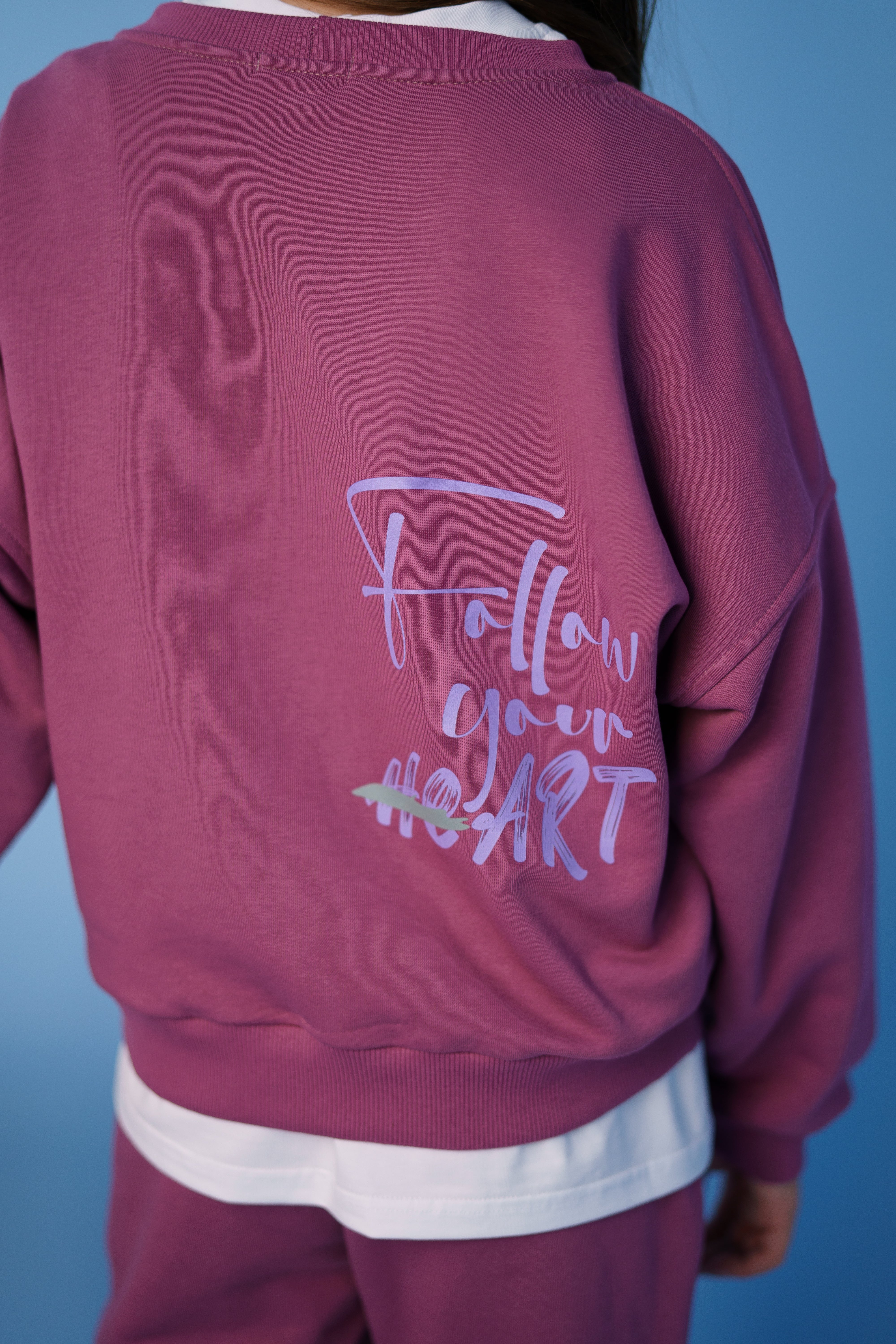 pinted phrase follow your heart on the backside of the sweatshirt - part of the pink tracksuit by Lemoni