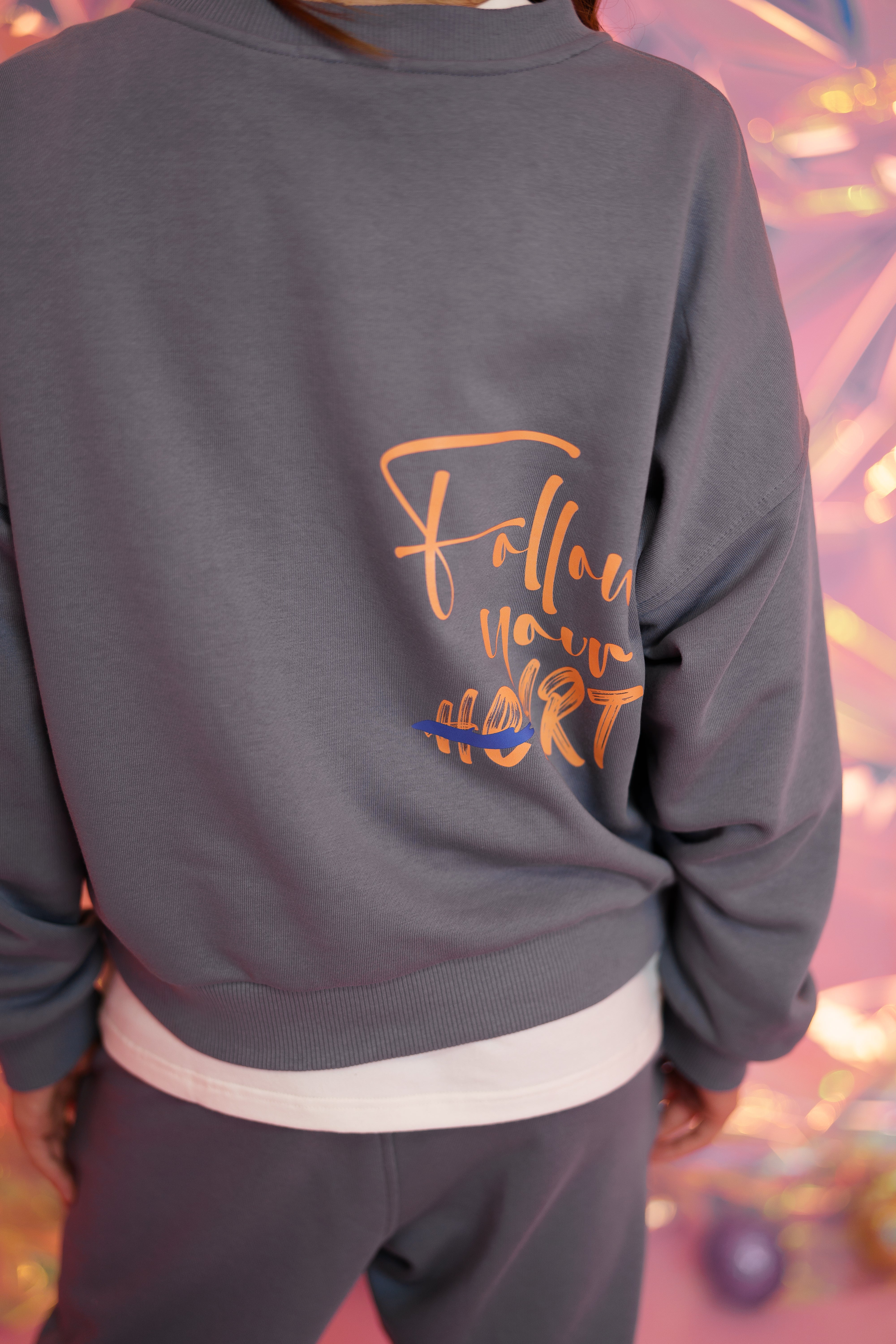 printed phrase follow your heart on the backside of the sweatshirt - part of the tracksuit by Lemoni